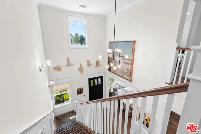a view of a hallway with furniture and front door