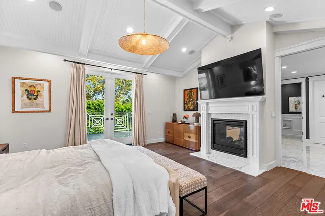 a bedroom with a bed and a fireplace