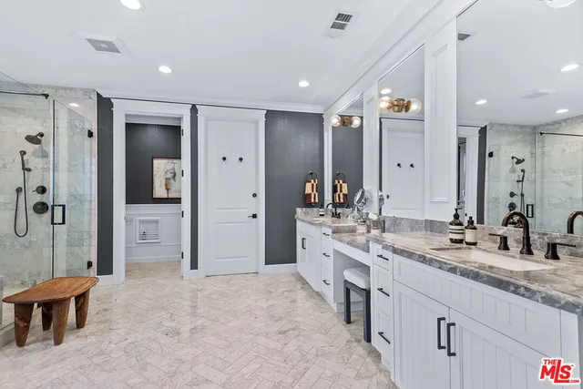 a spacious bathroom with a granite countertop sink mirror and a shower