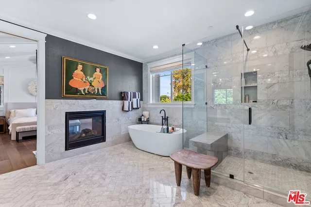 a spacious bathroom with a sink a mirror a bathtub and a shower