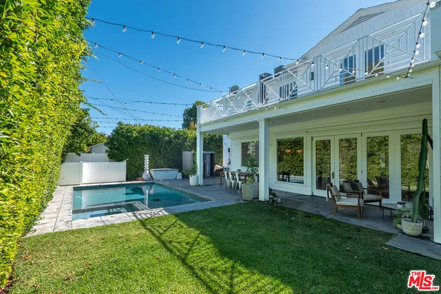 a view of a house with backyard porch and sitting area