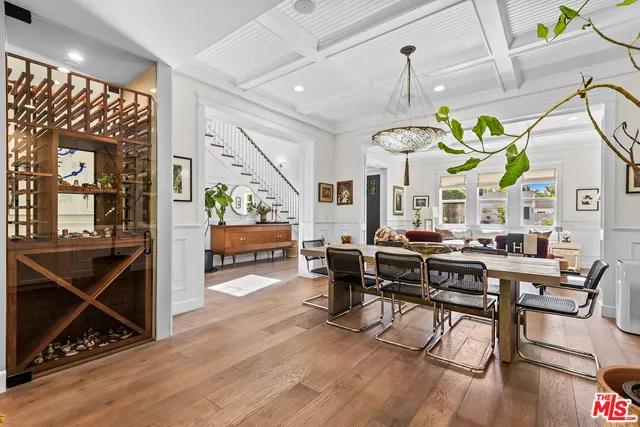 a living room with dining table and a wooden floor