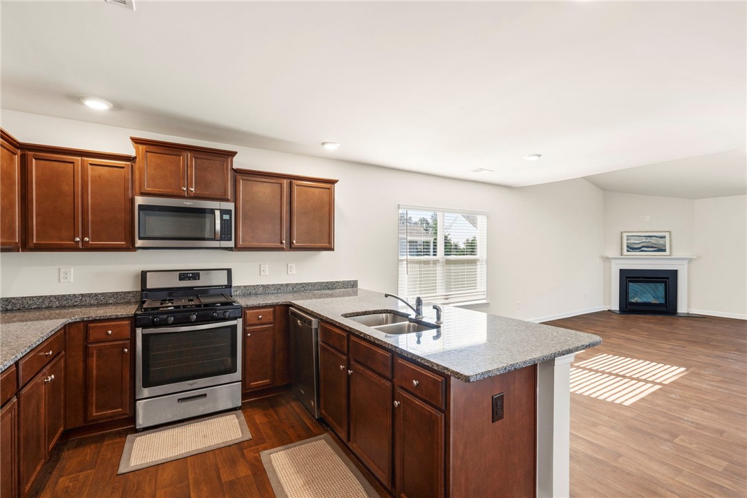 205 Hillendale Way Pelzer, SC 29669 - Photo 11 of 29 This open concept kitchen flows seamlessly into the living space, perfect for everyday living.