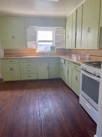 a kitchen with cabinets a sink and a stove