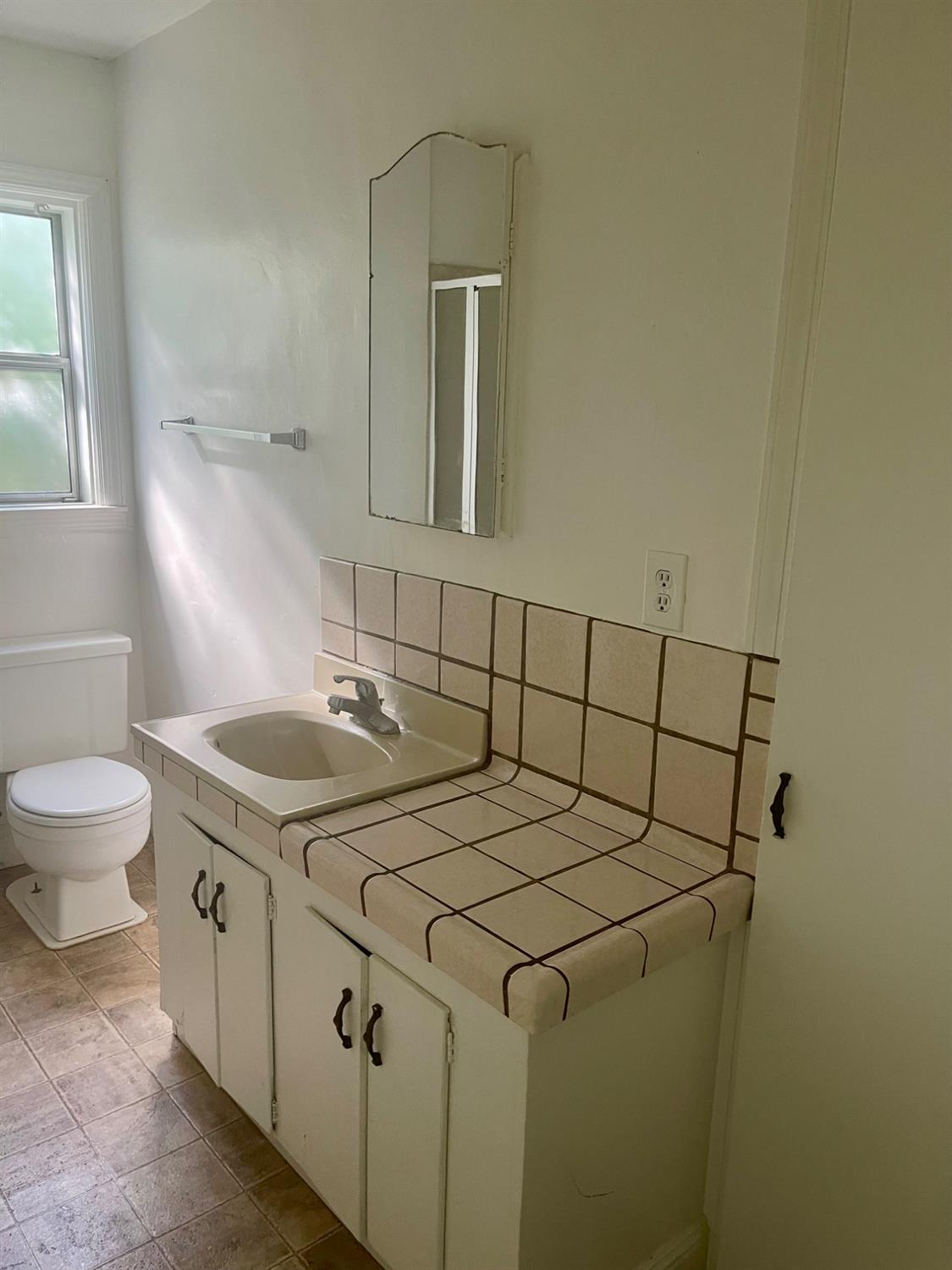 390 Nevada Street Gridley, CA 95948 - Photo 23 of 25 a bathroom with a sink and a toilet