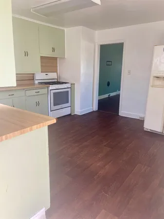 a kitchen with a stove and a refrigerator