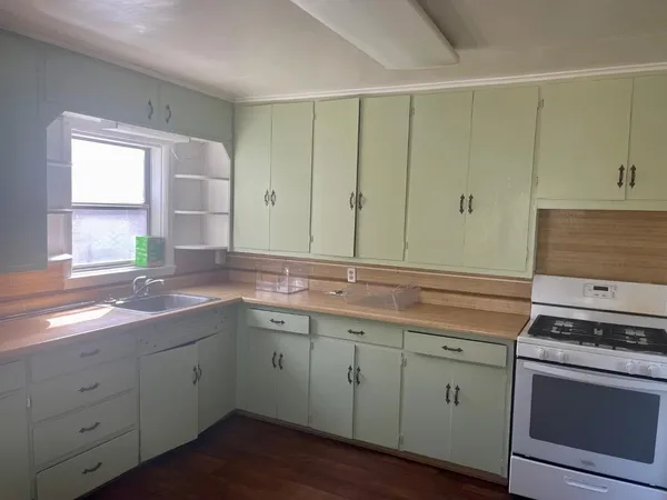 a kitchen with a sink stove and cabinets