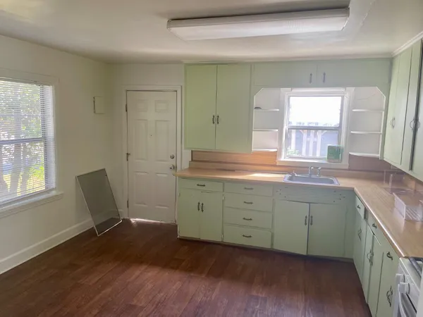a spacious bathroom with a double vanity sink a mirror and a window