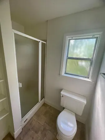 a white toilet sitting next to a bathroom sink