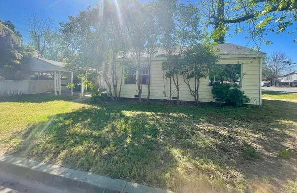 a view of a backyard with swimming pool