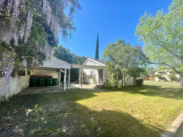 a view of a house with a yard and sitting area