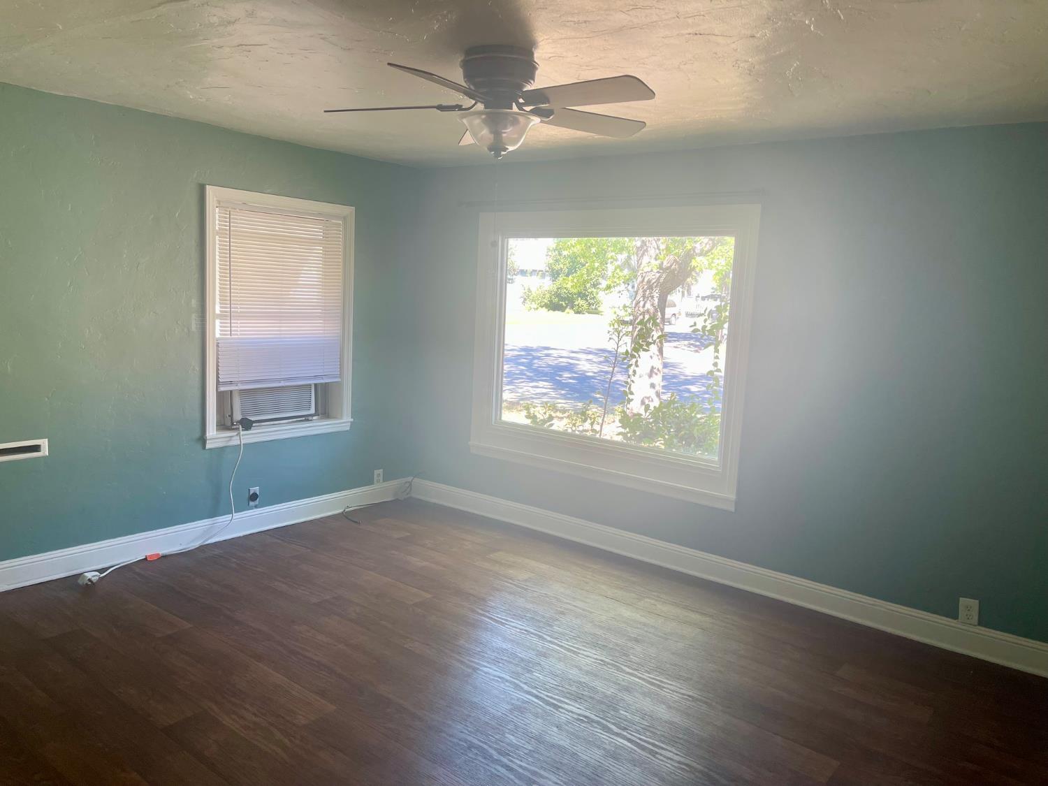390 Nevada Street Gridley, CA 95948 - Photo 8 of 25 an empty room with wooden floor chandelier and windows