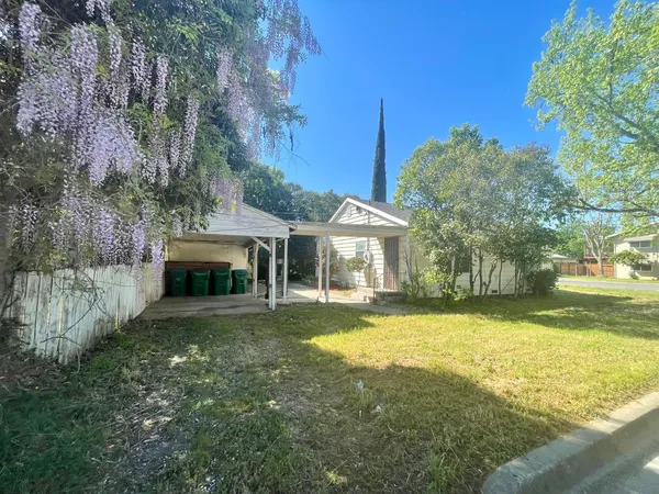 a view of a house with a yard and sitting area