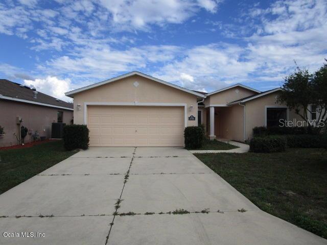 1735 Southwest 155th Place Road Ocala, FL 34473 - Photo 1 of 1 a front view of a house with a yard and a garage
