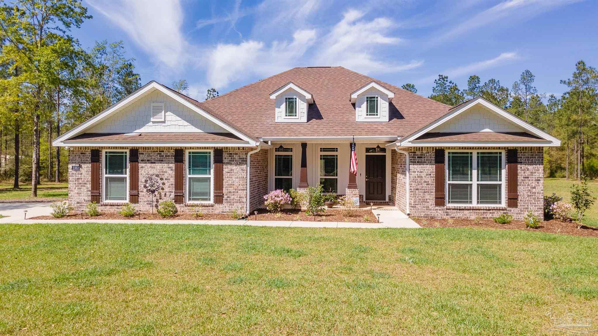 2383 Bud Diamond Road Jay, FL 32565 - Photo 1 of 50 a front view of a house with a garden and porch