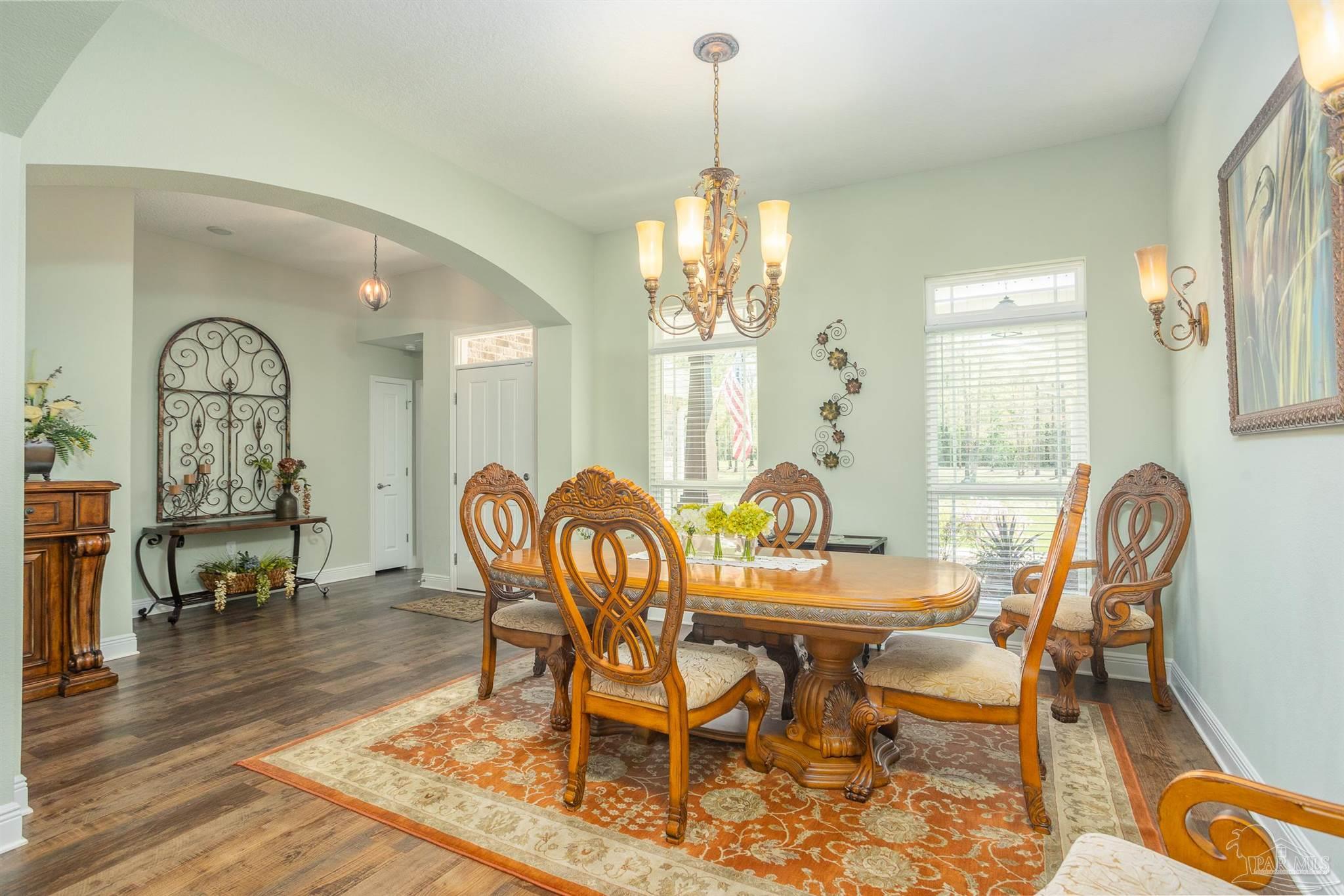 2383 Bud Diamond Road Jay, FL 32565 - Photo 15 of 50 a dining room with furniture a chandelier and wooden floor
