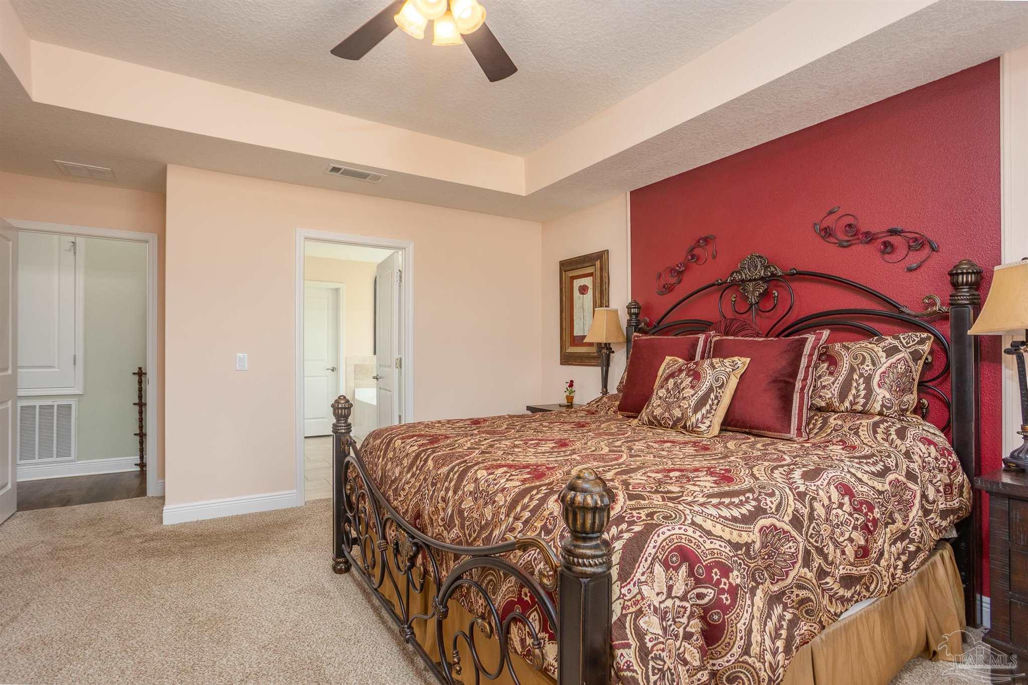 2383 Bud Diamond Road Jay, FL 32565 - Photo 16 of 50 a bedroom with a large bed and a chandelier