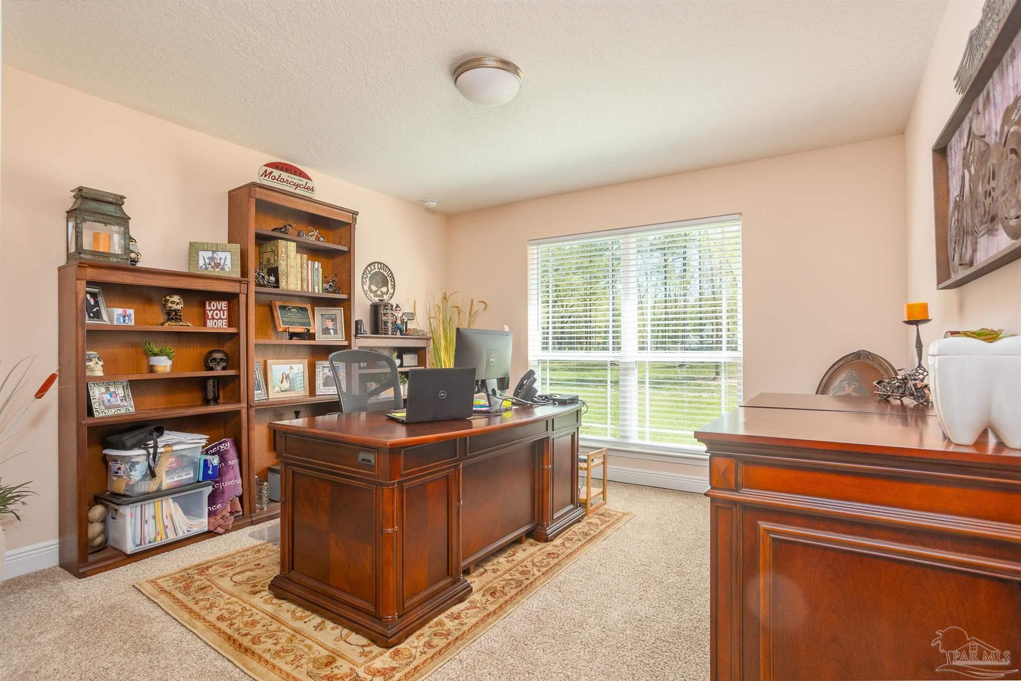 2383 Bud Diamond Road Jay, FL 32565 - Photo 23 of 50 a living room with furniture a large window and bookshelf