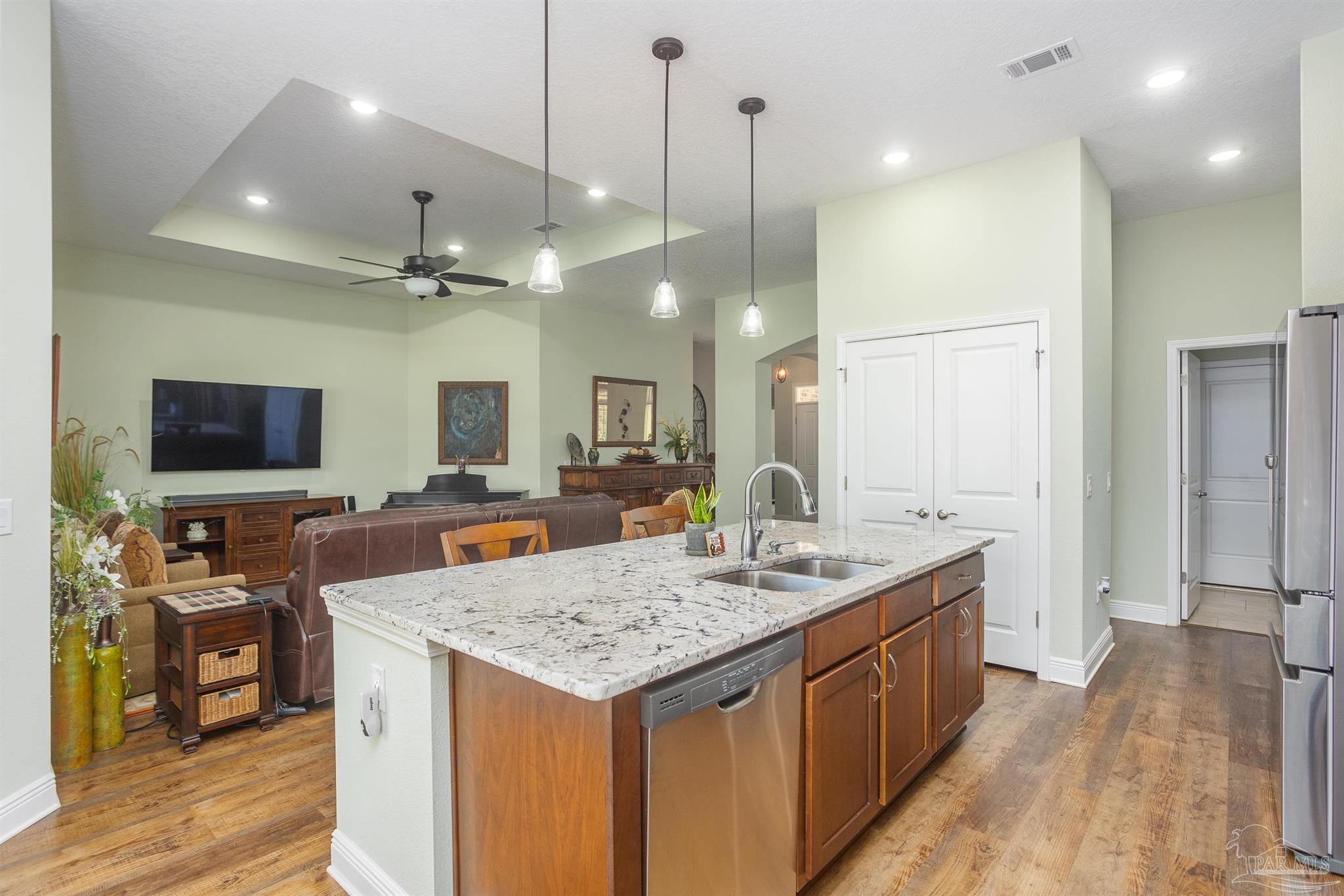 2383 Bud Diamond Road Jay, FL 32565 - Photo 7 of 50 a large kitchen with kitchen island a sink stove and wooden floor