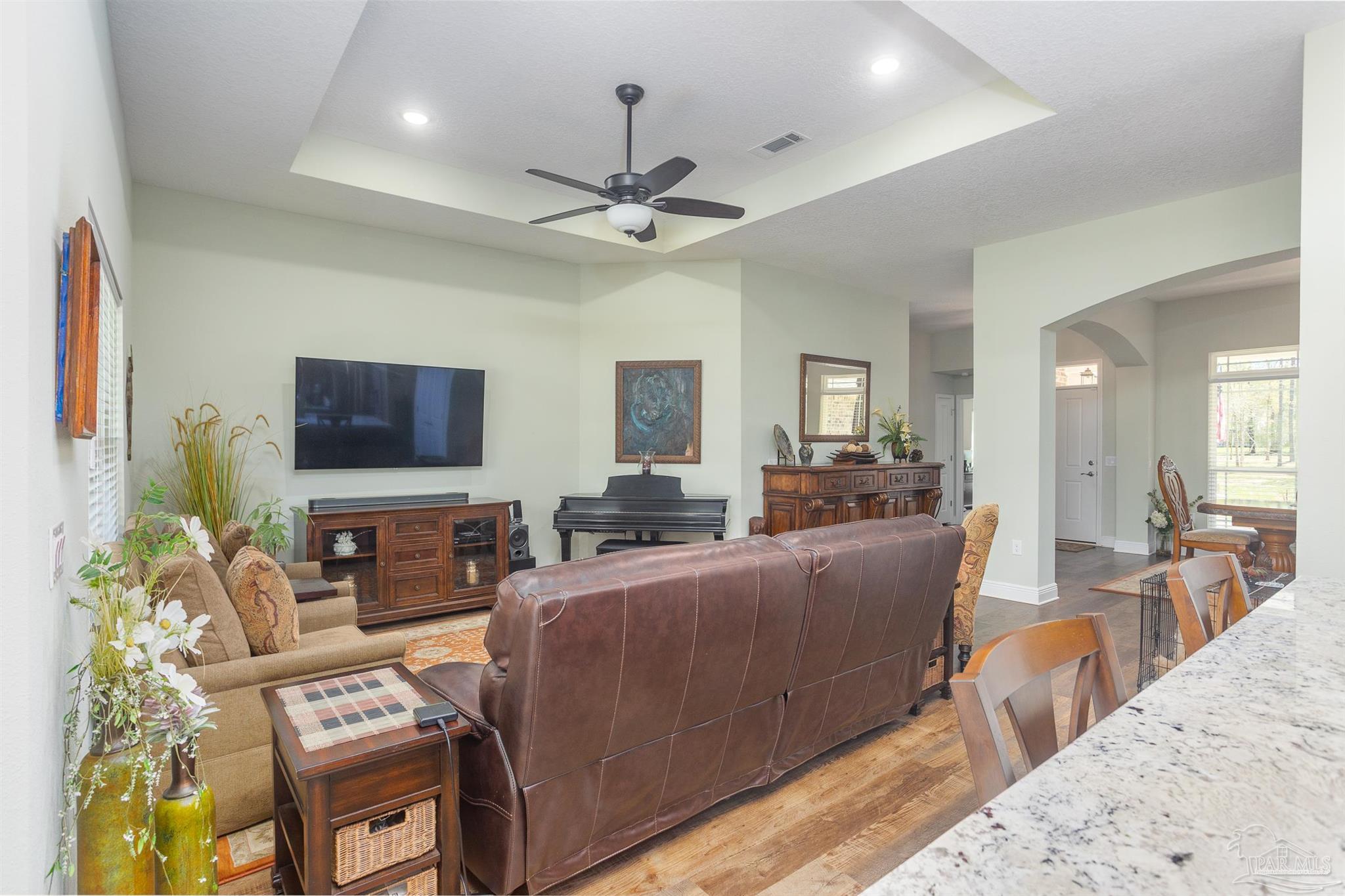 2383 Bud Diamond Road Jay, FL 32565 - Photo 10 of 50 a living room with furniture a ceiling fan and a flat screen tv