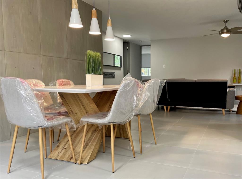 290 Av. Sta. Ana Guaynabo, Bayamón 00969 - Photo 11 of 23 a view of a dining room with furniture and a potted plant