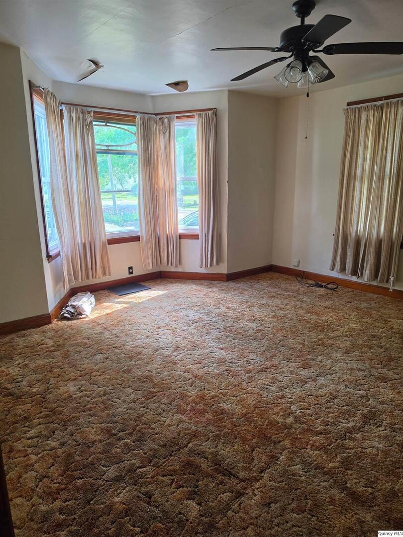 304 West 3rd Street Golden, IL 62339 - Photo 5 of 18 an empty room with windows
