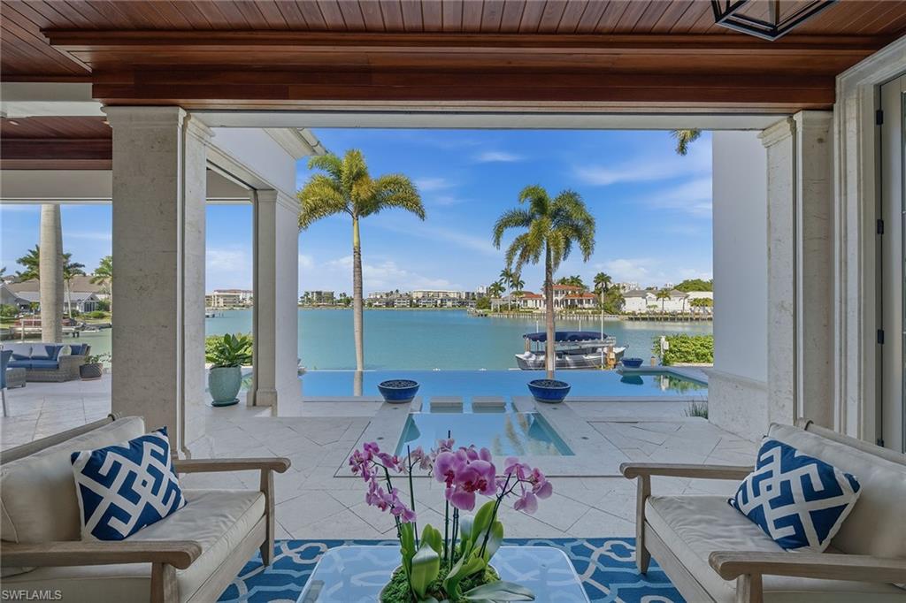 3125 Leeward Lane Naples, FL 34103 - Photo 12 of 30 a living room with furniture and flowers
