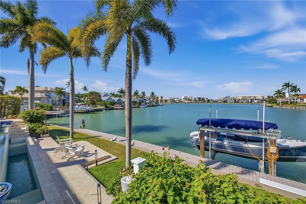 3125 Leeward Lane Naples, FL 34103 - Photo 13 of 30 a view of a lake with a patio