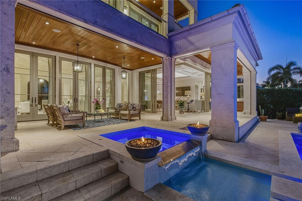 3125 Leeward Lane Naples, FL 34103 - Photo 15 of 30 a living room with furniture a rug and a floor to ceiling window