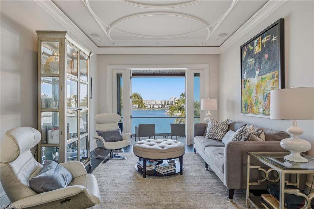 3125 Leeward Lane Naples, FL 34103 - Photo 20 of 30 a living room with furniture and a large window