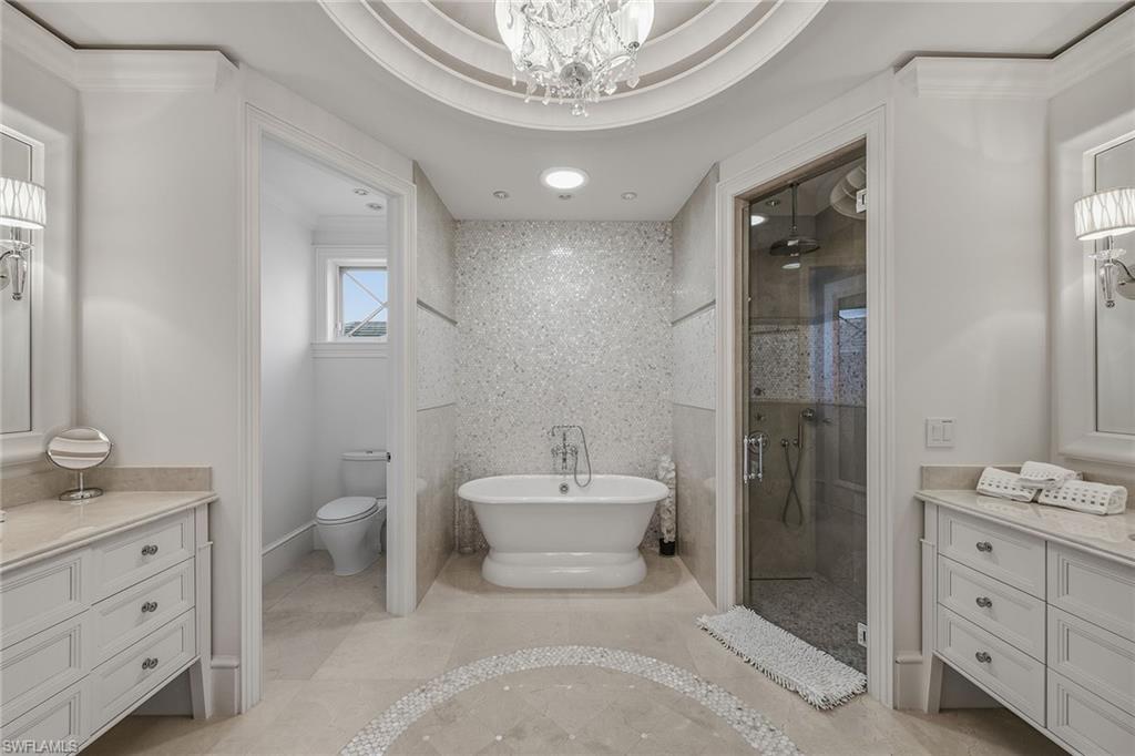 3125 Leeward Lane Naples, FL 34103 - Photo 22 of 30 a bathroom with a sink a toilet and shower