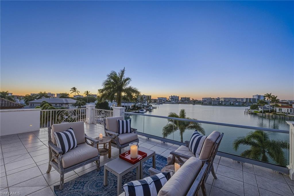 3125 Leeward Lane Naples, FL 34103 - Photo 3 of 30 a view of a chairs and table in patio