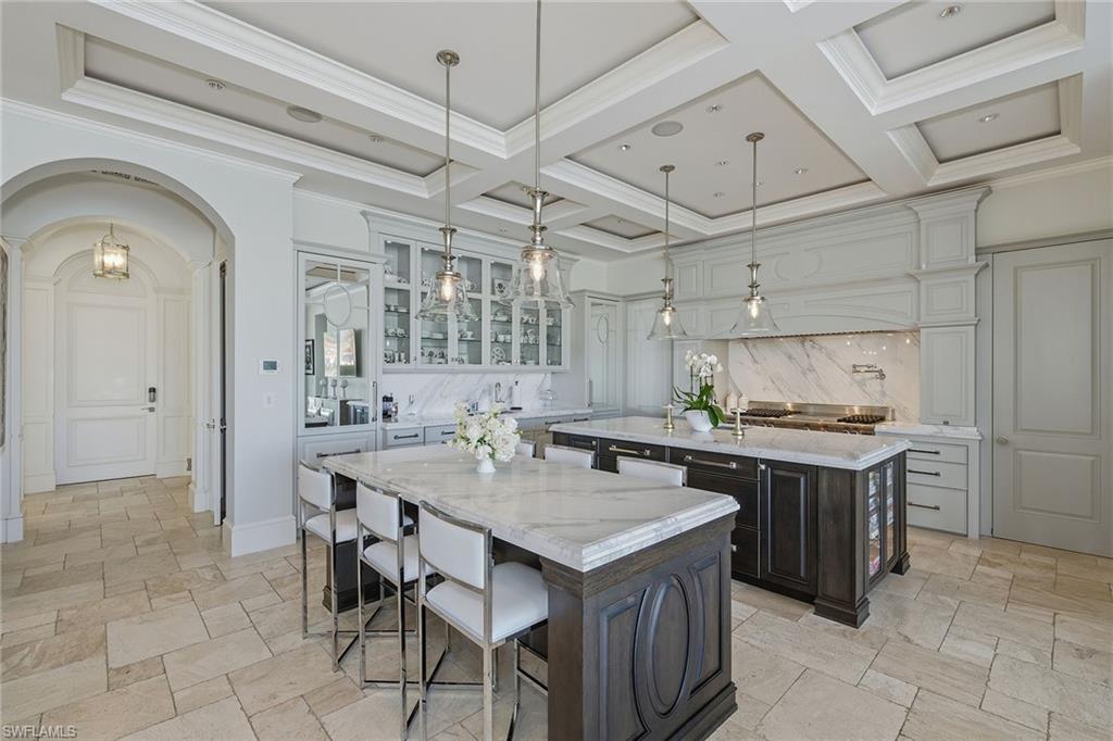 3125 Leeward Lane Naples, FL 34103 - Photo 5 of 30 a kitchen with a stove a refrigerator and wooden cabinets