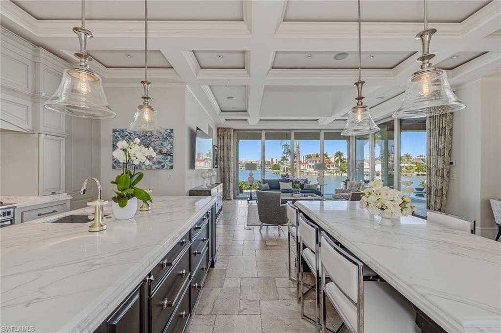 3125 Leeward Lane Naples, FL 34103 - Photo 6 of 30 a kitchen with counter top space and wooden floor