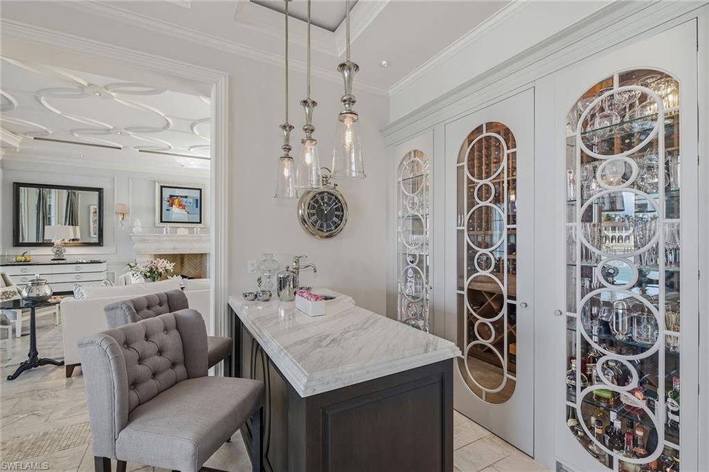 3125 Leeward Lane Naples, FL 34103 - Photo 7 of 30 a view of a dining area with furniture and chandelier