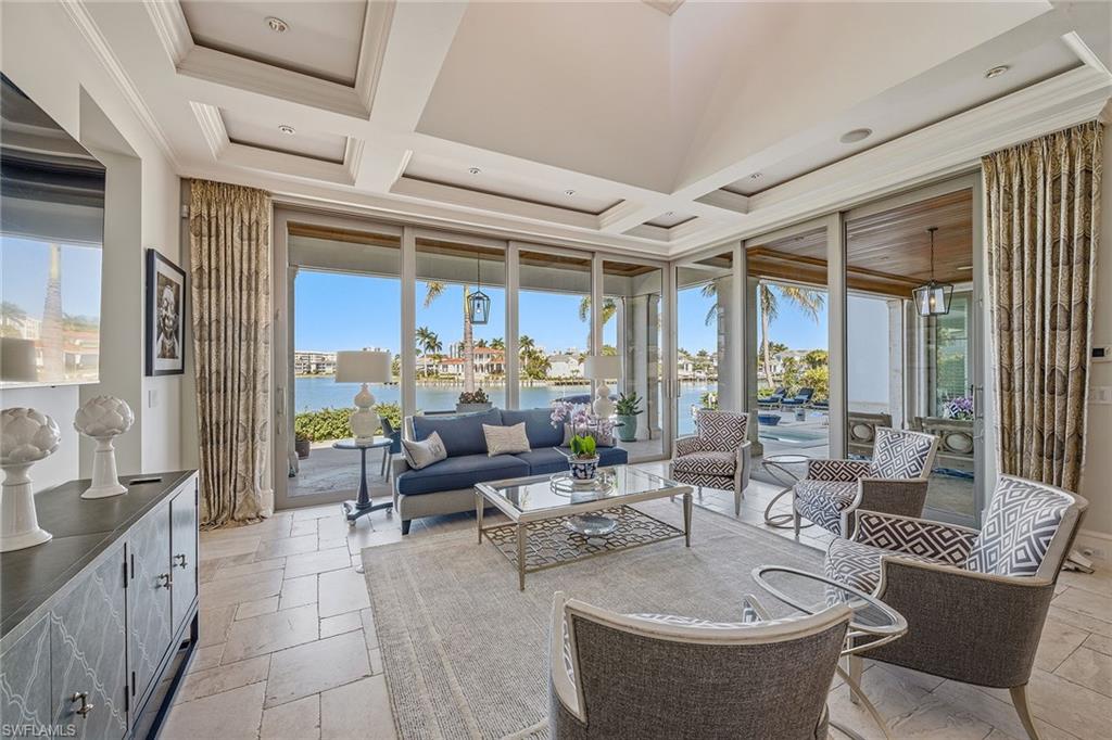 3125 Leeward Lane Naples, FL 34103 - Photo 8 of 30 a living room with furniture and a large window