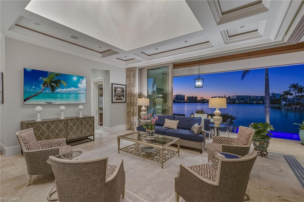 3125 Leeward Lane Naples, FL 34103 - Photo 9 of 30 a living room with furniture and a fireplace