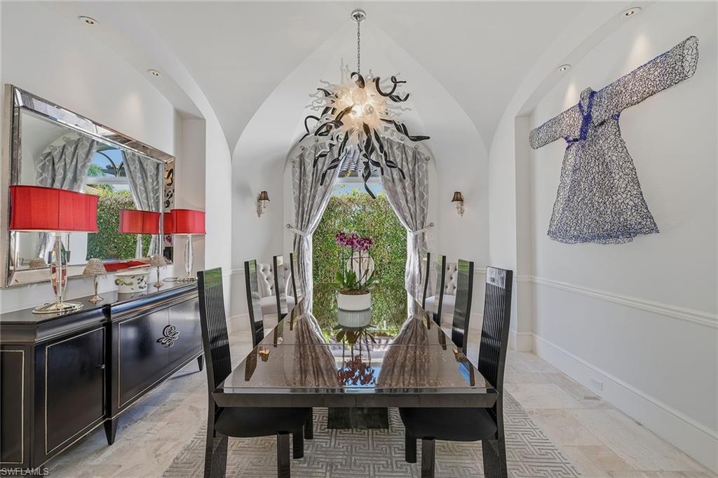 3125 Leeward Lane Naples, FL 34103 - Photo 10 of 30 a view of a dining room with furniture window and wooden floor