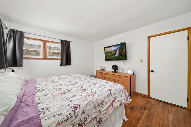 228 West Taylor Street DeKalb, IL 60115 - Photo 13 of 30 a bedroom with a bed and a flat screen tv