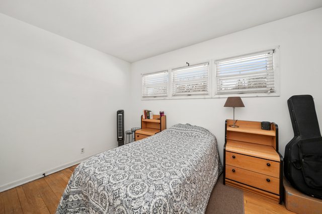 228 West Taylor Street DeKalb, IL 60115 - Photo 15 of 30 a bedroom with a bed and a window