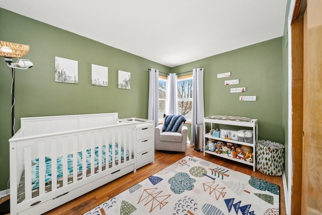 228 West Taylor Street DeKalb, IL 60115 - Photo 16 of 30 a bedroom with furniture and a baby crib