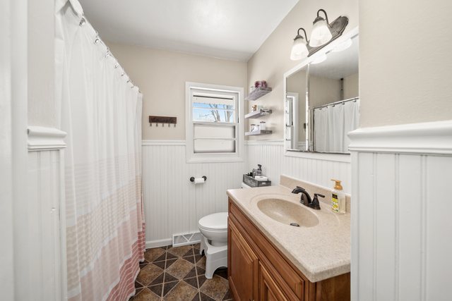 228 West Taylor Street DeKalb, IL 60115 - Photo 18 of 30 a bathroom with a sink toilet and shower