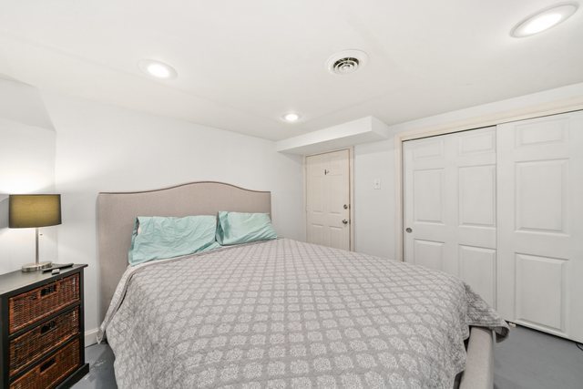 228 West Taylor Street DeKalb, IL 60115 - Photo 20 of 30 a large white bed in a white room