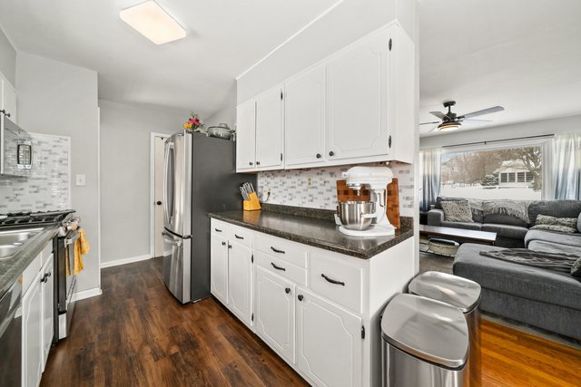 228 West Taylor Street DeKalb, IL 60115 - Photo 9 of 30 a kitchen with stainless steel appliances granite countertop a stove and a refrigerator