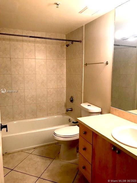 2630 Southwest 28th Street, Unit 26 Miami, FL 33133 - Photo 2 of 6 a bathroom with a sink toilet and shower