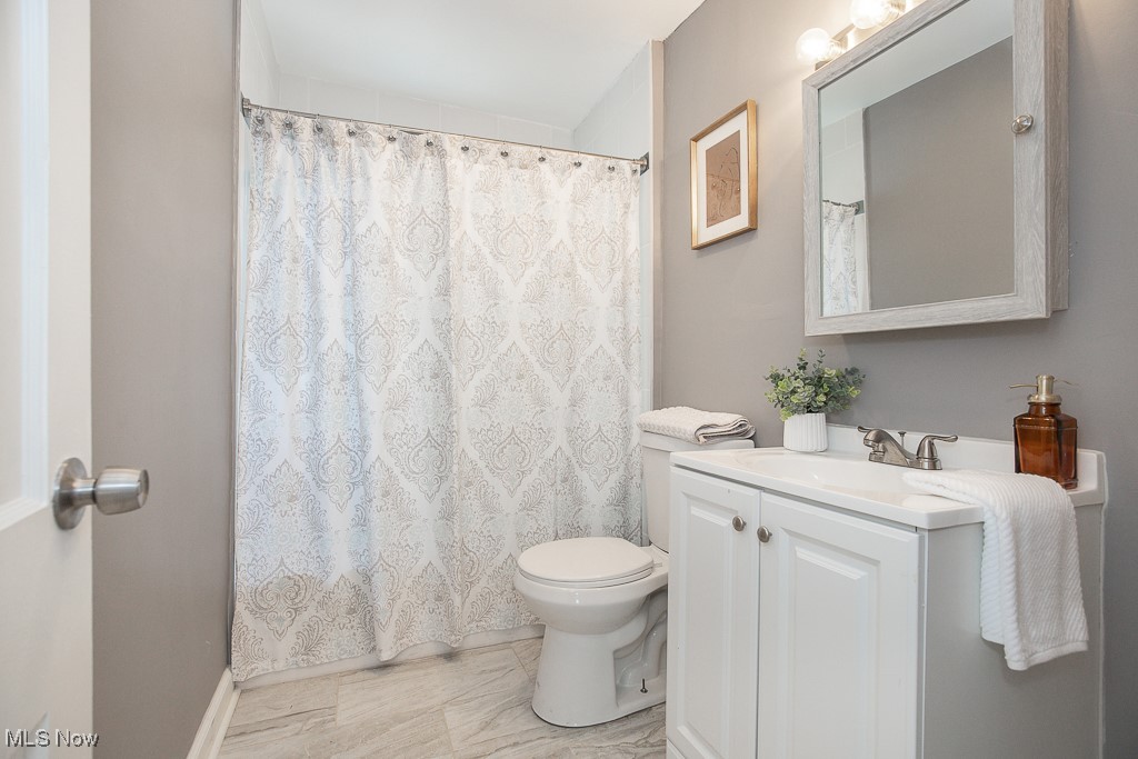 1547 Genesee Road South Euclid, OH 44121 - Photo 9 of 36 Bathroom with toilet, vanity, and marble finish flooring
