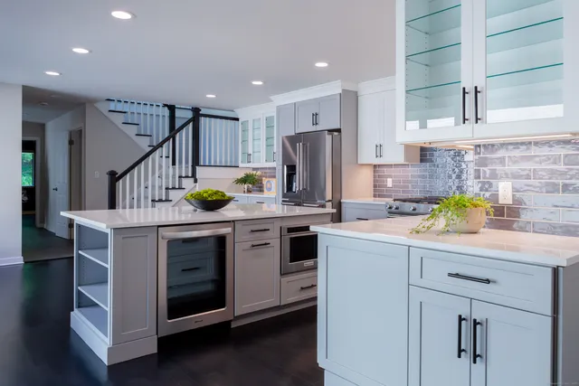 a kitchen with a sink a counter space appliances and cabinets
