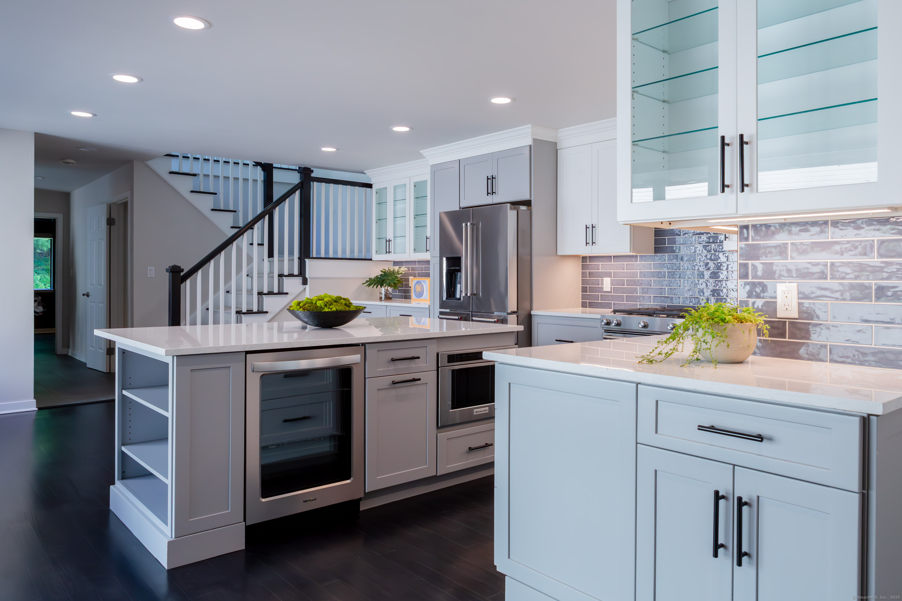 a kitchen with a sink a counter space appliances and cabinets