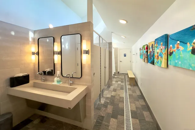 a spacious bathroom with a double vanity sink and a mirror