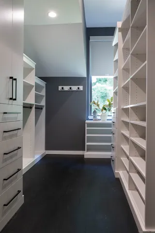 a view of walk in closet with empty racks